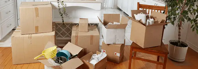 Packed moving boxes and household items in a kitchen before move-out or move-in cleaning, Jacksonville, FL.